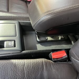 BMW i3 accessory that creates a hidden compartment and shelf under the armrest